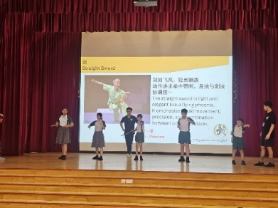 Students performing a Chinese language presentation on the school stage.