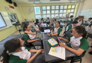 Students collaborating in a Chinese language lesson in the classroom.