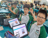 Students using tablets during an interactive Chinese language lesson.