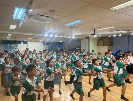 Students participating in a traditional Malay dance performance.
