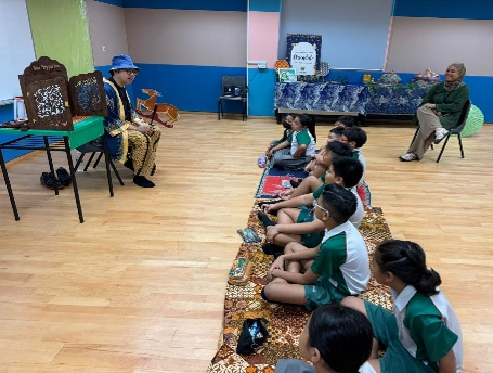 Students listening to a traditional Malay storytelling session in the classroom.