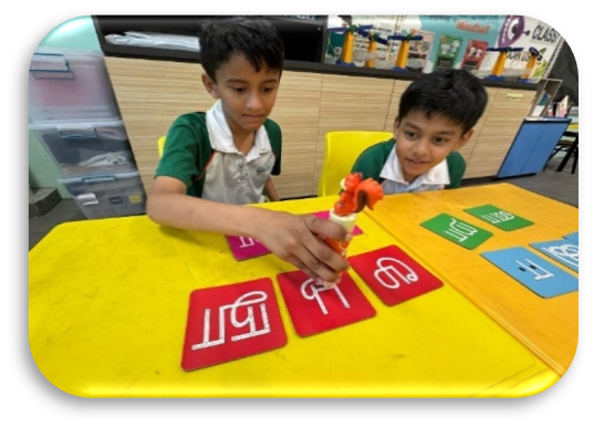 Students matching Tamil letters in a hands-on classroom learning activity.