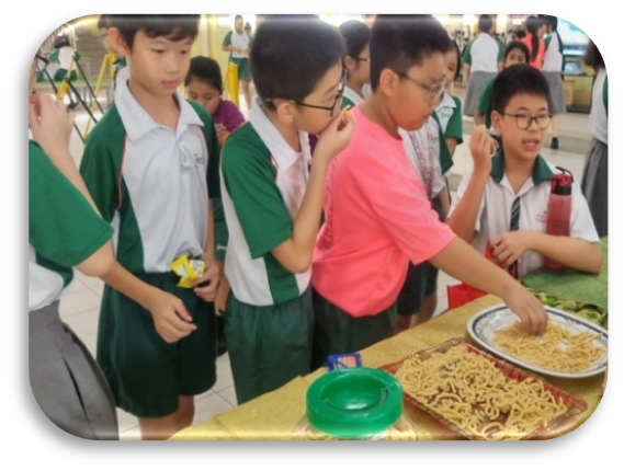 Students exploring traditional snacks during a Tamil cultural learning activity.